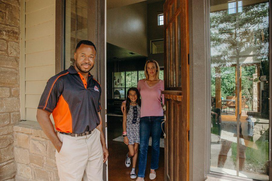 All Valley Pop-A-Lock technician helping a family at their front door